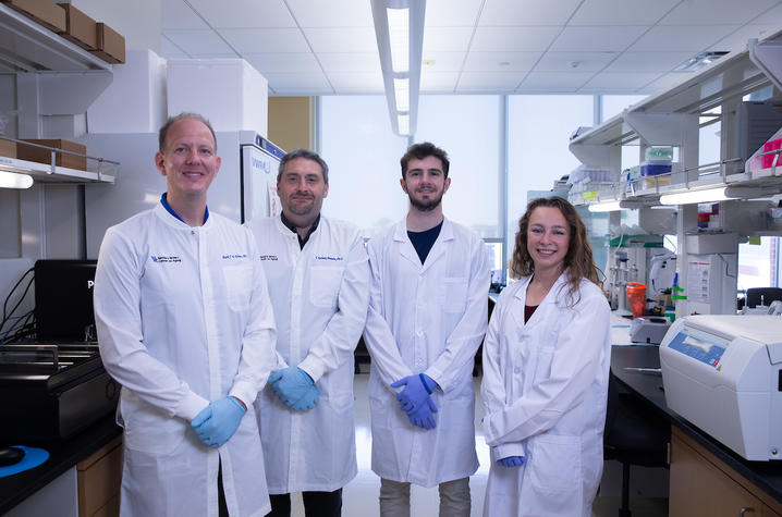 Ebbert and his team of three researchers standing in their lab.