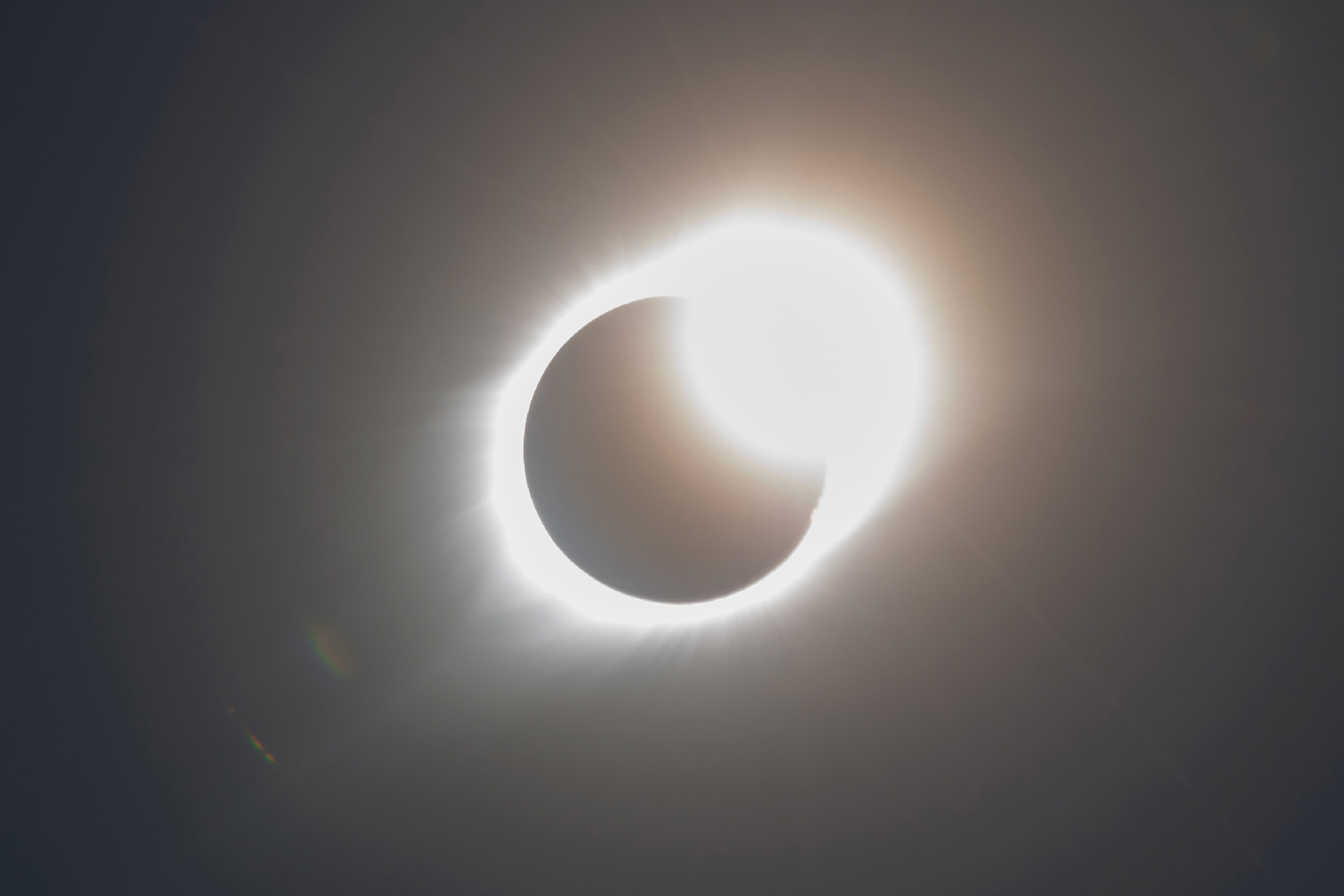 The silhouette of the moon passes in front of the sun. A ring of light surrounds the silhouette.