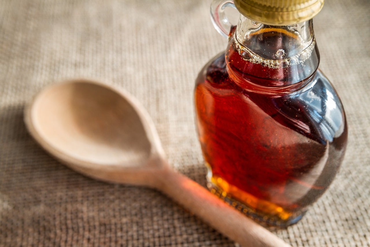 Jar of Maple Syrup and Spoon