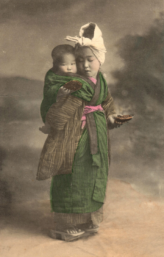 FIGURE 2. Young girl feeding a rice cracker to her infant charge, 1912. Courtesy of the author.