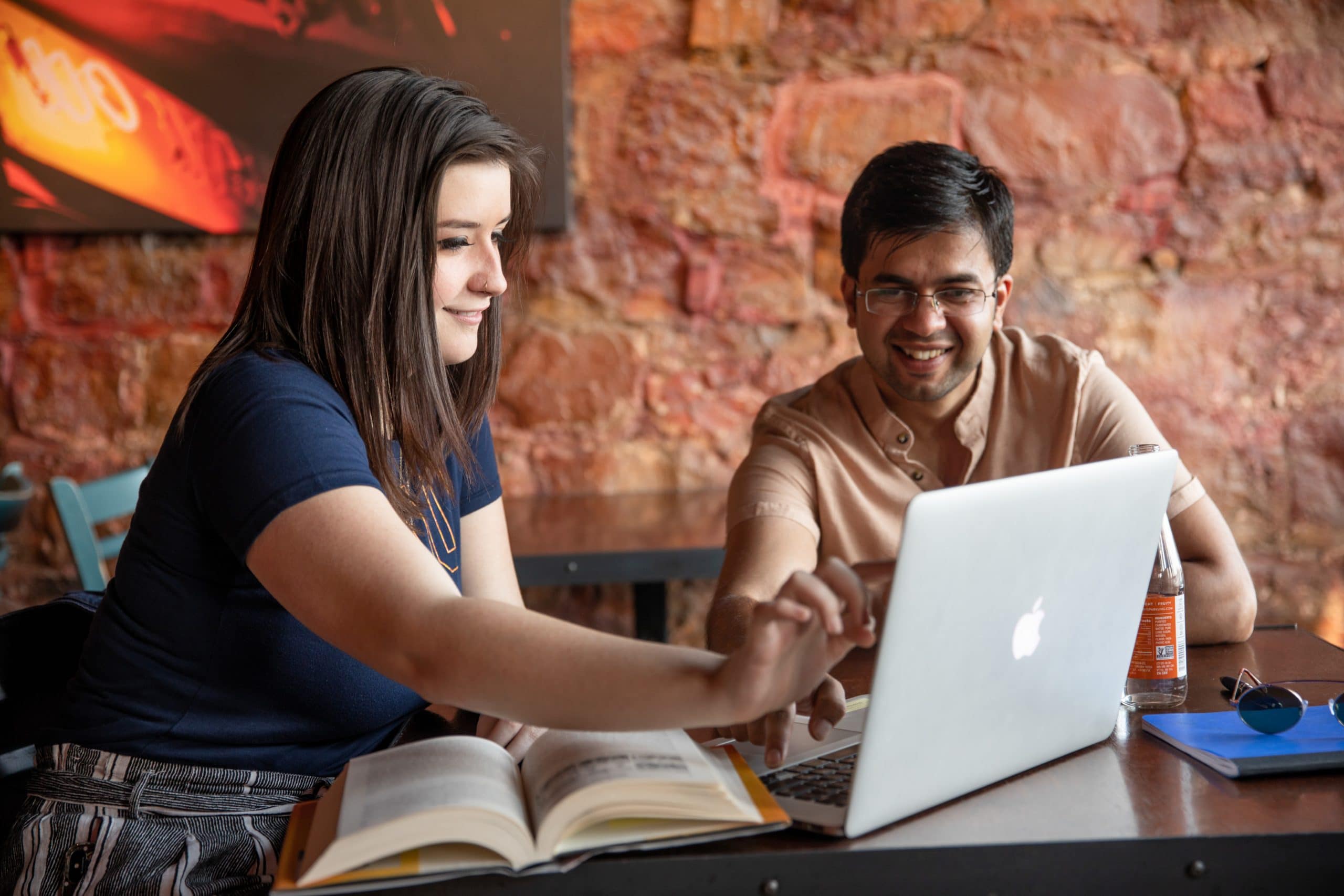 Grad students working together on the laptop.