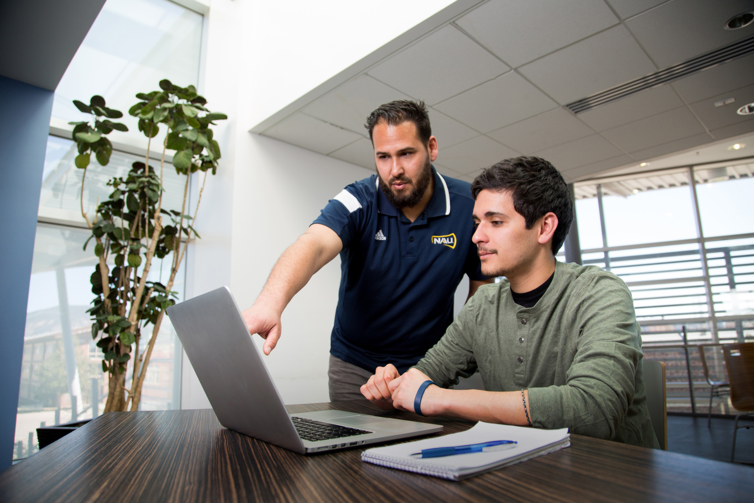 A photo of a student getting help from an advisor.