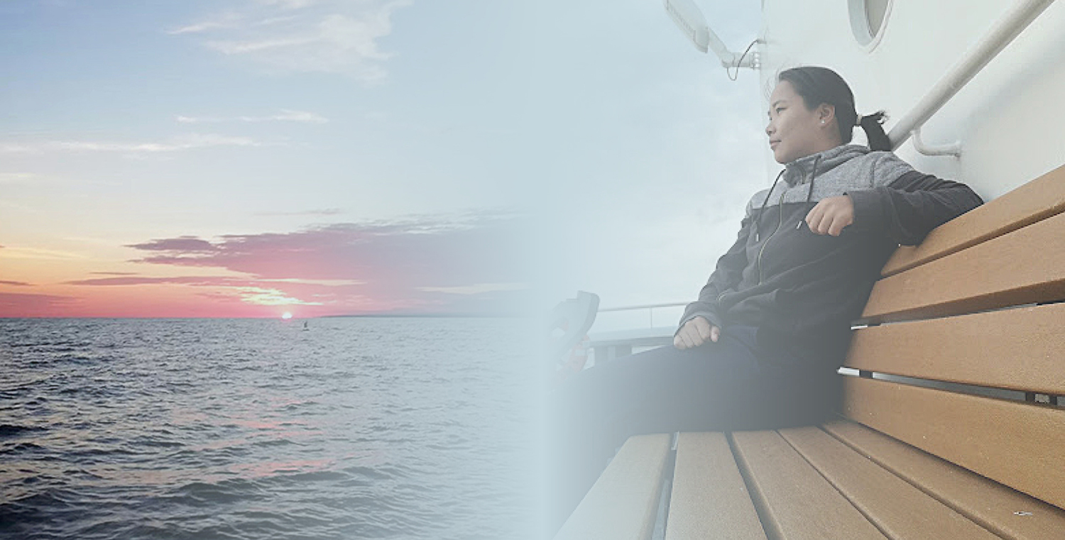 An image of Firosa Tomohamat, from Suriname’s Maritime Authority, sitting on a bench on deck 2 of NOAA Ship Thomas Jefferson.