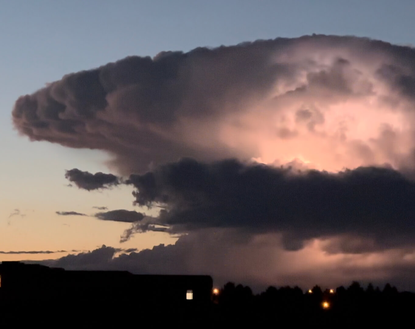 Large mushrooming cloud with light coming from the center