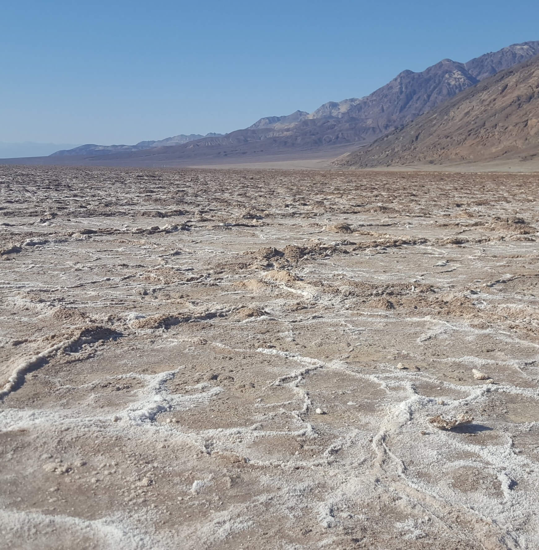 Dry ground desert like climate with mountains in the background