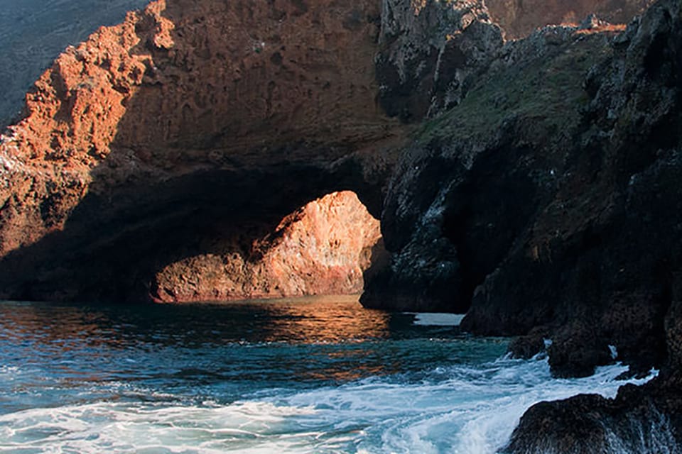 An image of an ocean shoreline met with a rocky formation