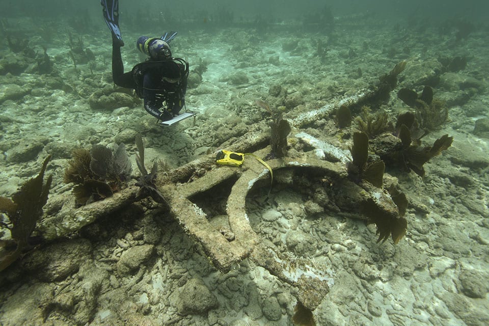 Brend Altmeier investigates the iron frame used to mount a letter onto the beacon at Eastern Sambo.