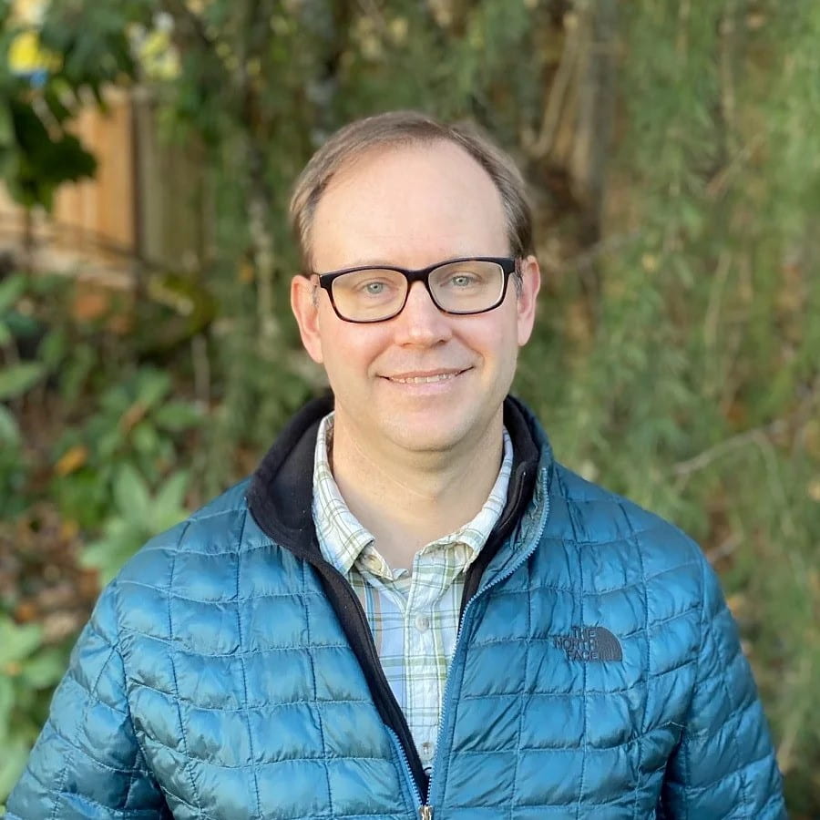 Man smiling for a headshot.