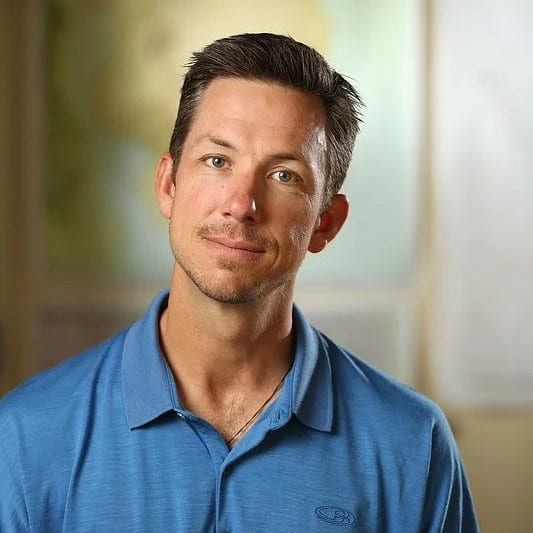 A man smiling for a headshot