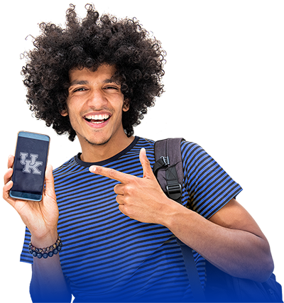 UKY Student holding a phone and poiting to the UK Logo