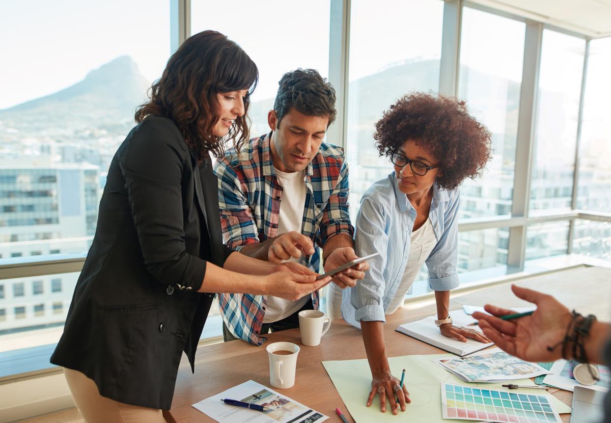 Colleagues working together in high-rise office suite