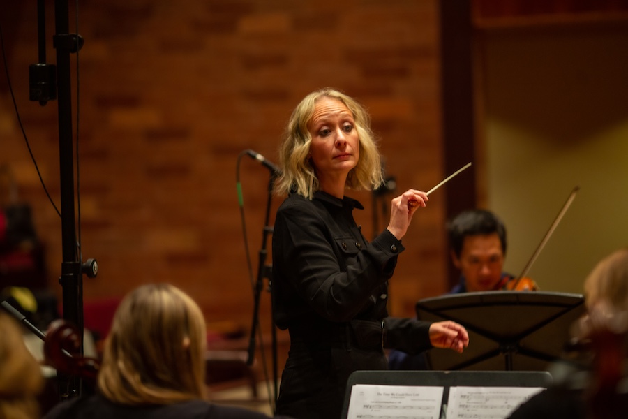 Christinia Giacona conducting an orchestra.