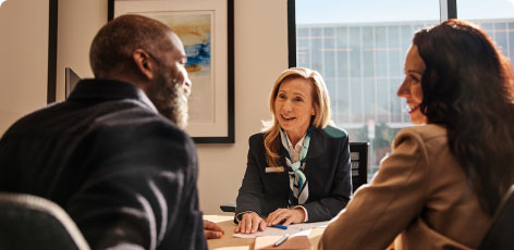 A Chase banker speaks to a couple in her office