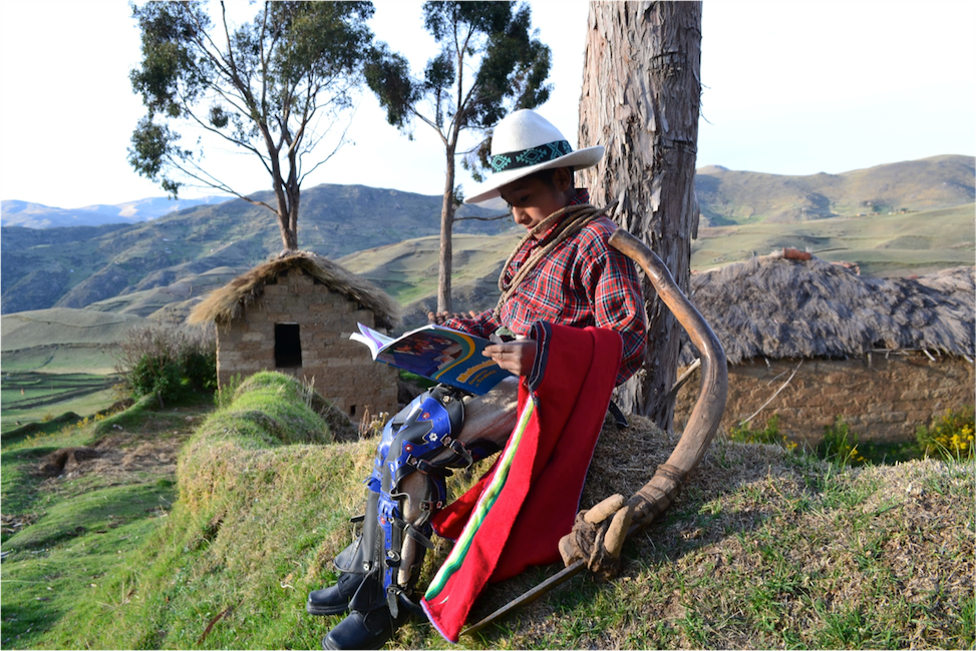 Photo of a man reading. Photo was provided by Minedulab in Peru