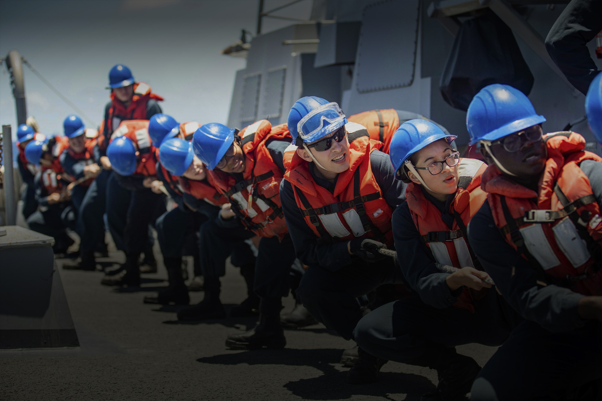 Soldiers pulling a rope on a ship