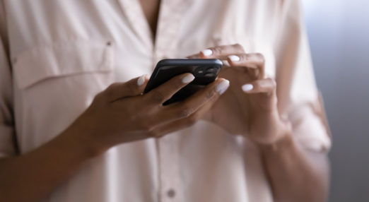 Close up image of a woman holding a smartphone