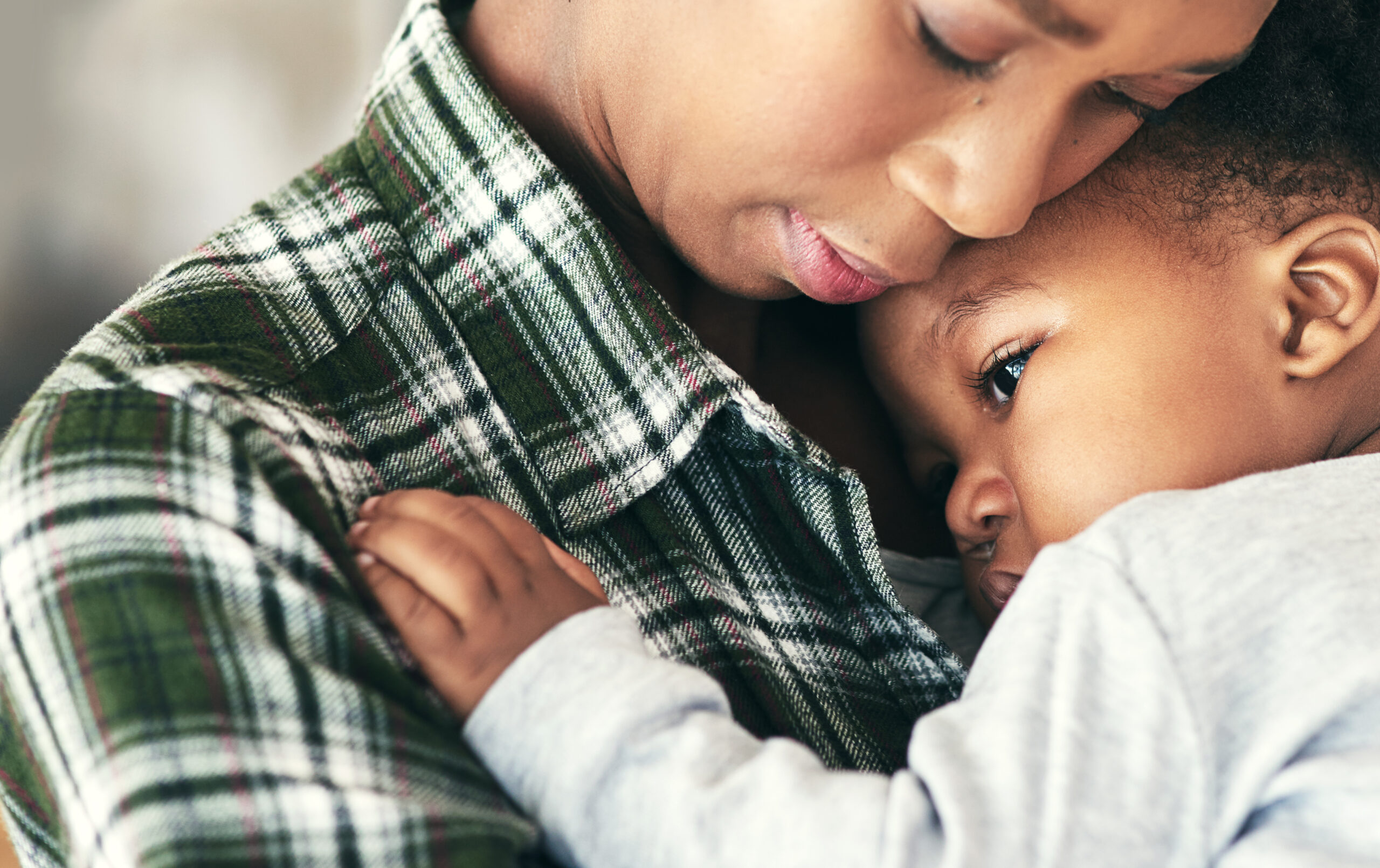 Close up image of a mother cradling her baby boy