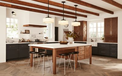 A rustic kitchen with warm wood stain and exposed wood beams.