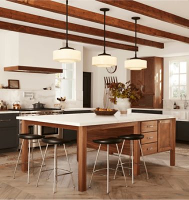 A rustic kitchen with warm wood stain and exposed wood beams.