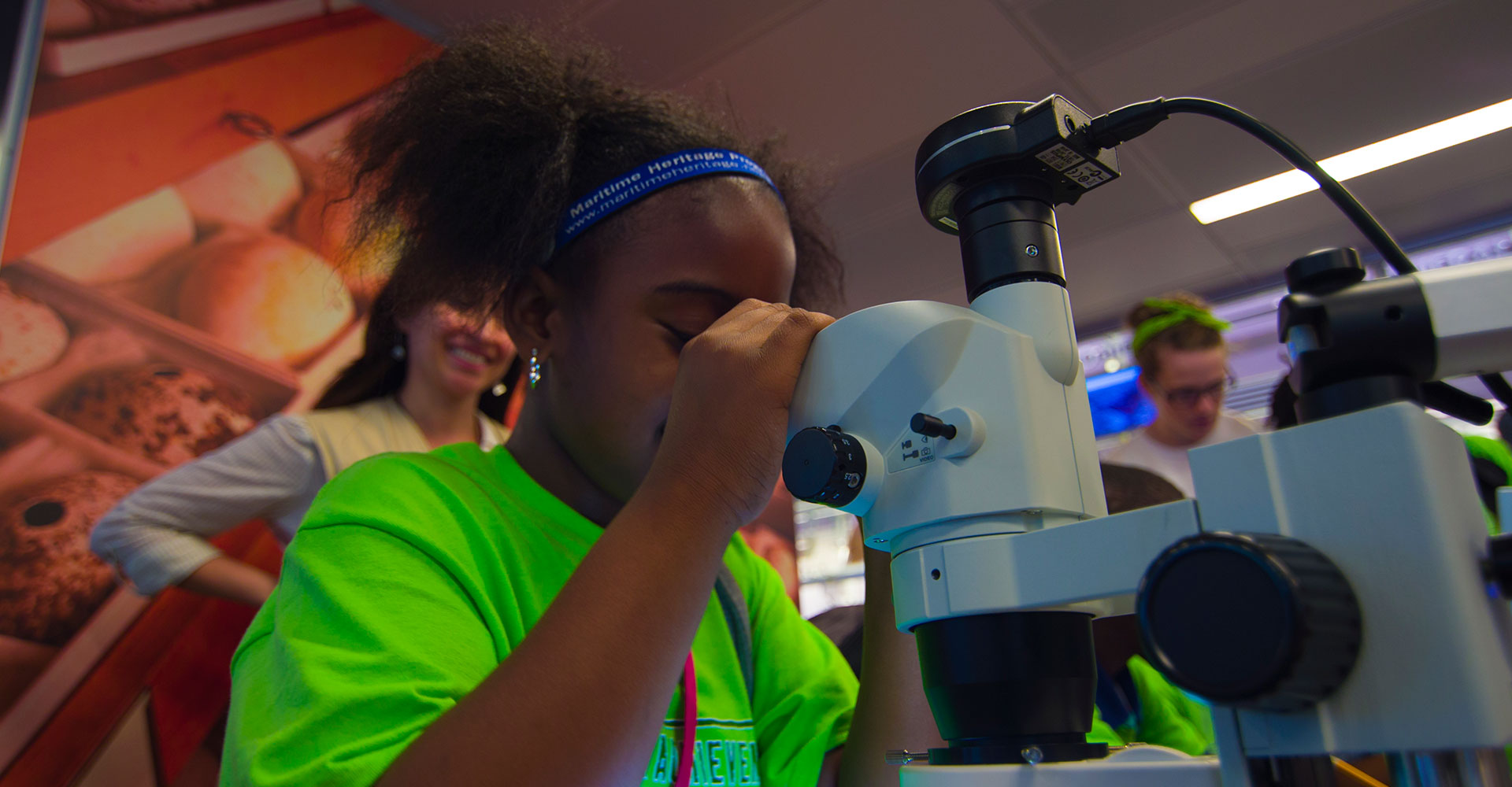 students observing a teacher holding a starfish