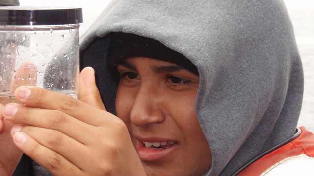 student inspecting ocean water