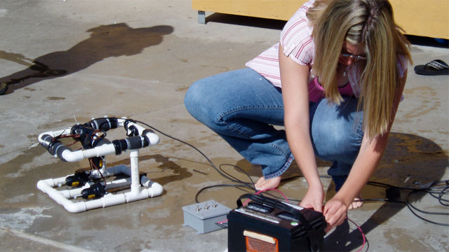 teacher putting together an rov