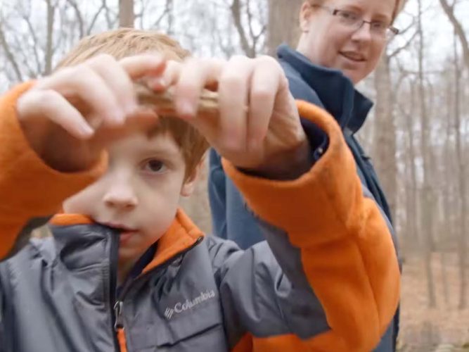 A parent and child on a nature walk.