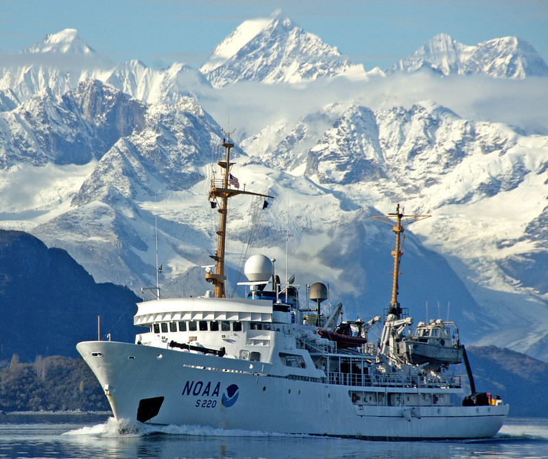 NOAA ship with mountains in background