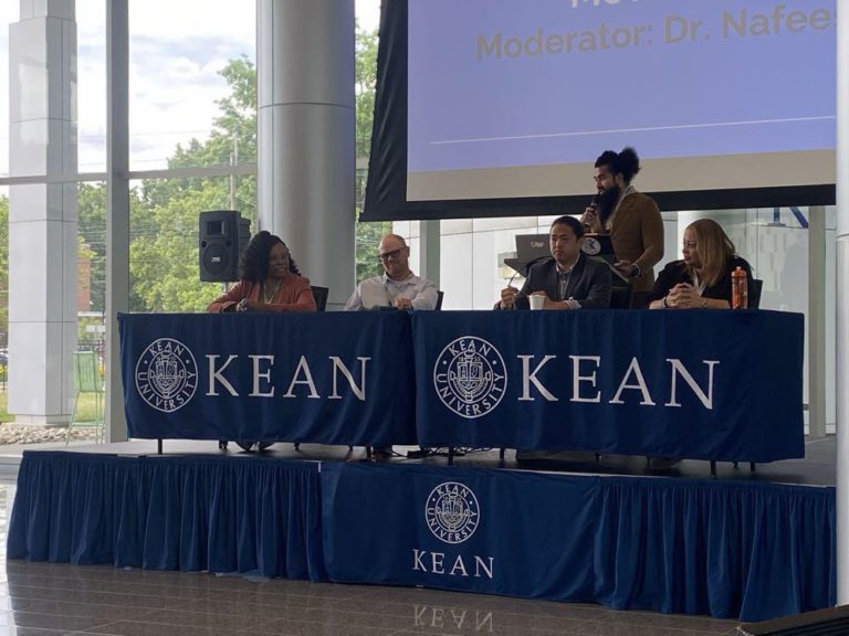 Drs. Moore and Newman sitting at a table during annual symposium