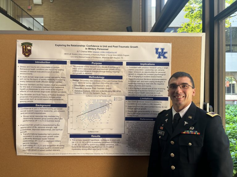 Col. Miller standing in front of his research poster at the symposium