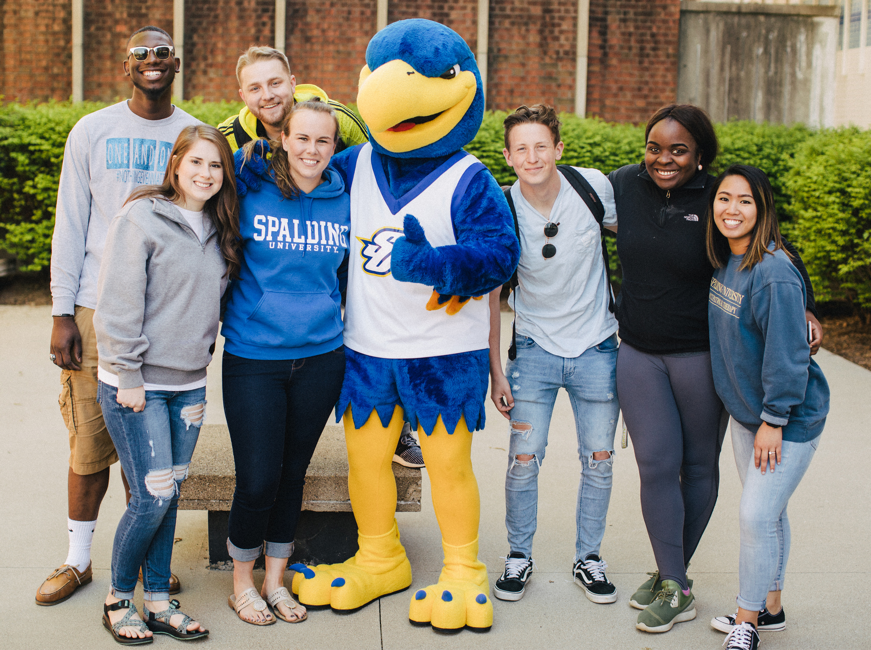 Students posing with Ollie the Eagle outside of the Spalding Library