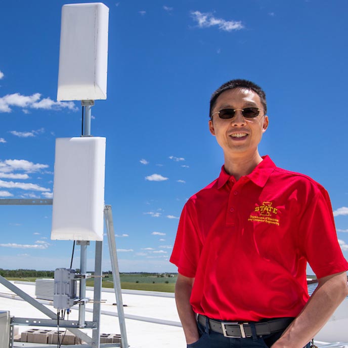 Hongwei Zhang poses outside with a broadband antennae