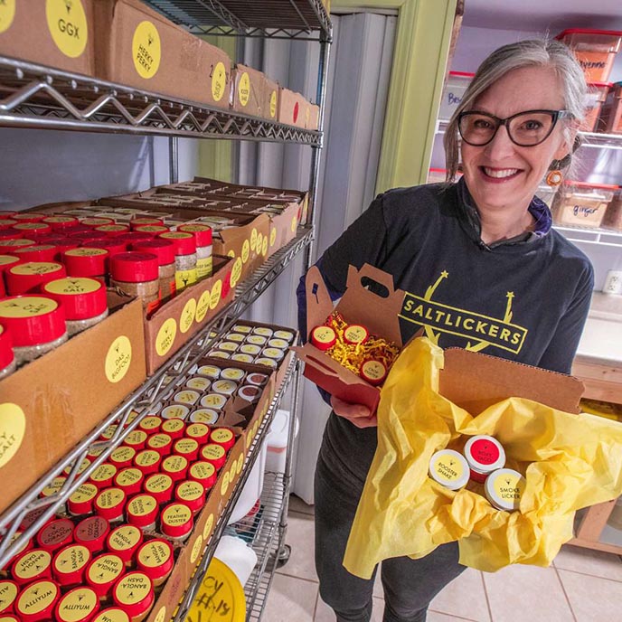 Jennifer Knox displays the variety of Saltlickers seasoning blends that she creates. Photo by Christopher Gannon