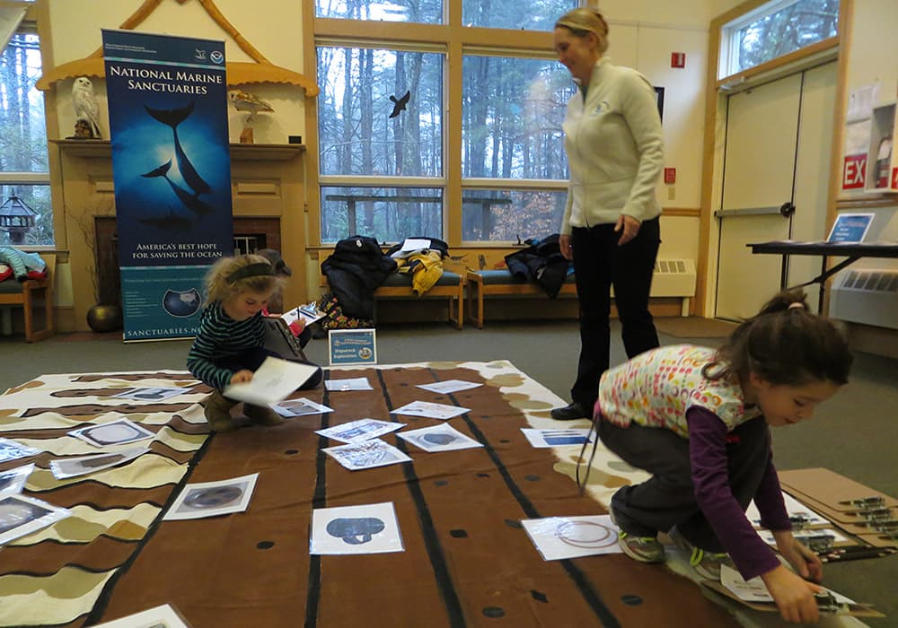 Children explore a mock shipwreck