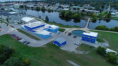 Aerial shot of blue and white buildings next to a river