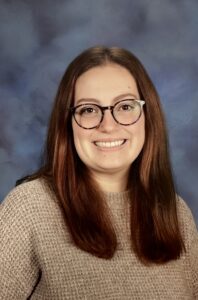 Yearbook photo of a brown-haired woman with glasses