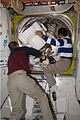 Tony Antonelli and Koichi Wakata assist Steve Swanson and Joseph Acaba (out of frame) as they return to the Quest Airlock as the EVA draws to a close.