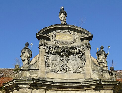 Above the Doksany Convent entry portal, coats of arms.