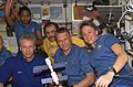 Expedition 13 and STS-121 crew members pose for a photo in the Zvezda Service Module