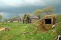 An oven, with cabins in the background