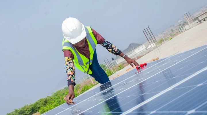 a person doing work on a solar panel