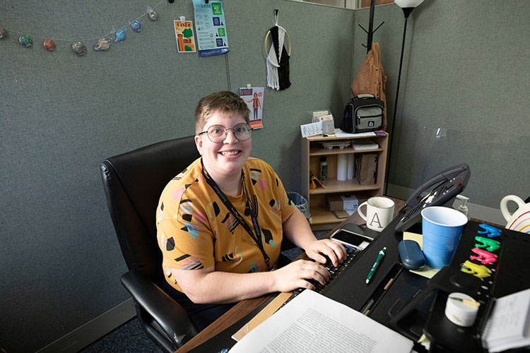 UWM social work major sitting at their desk