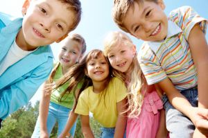 Smiling Kids Leaning Down into the Picture