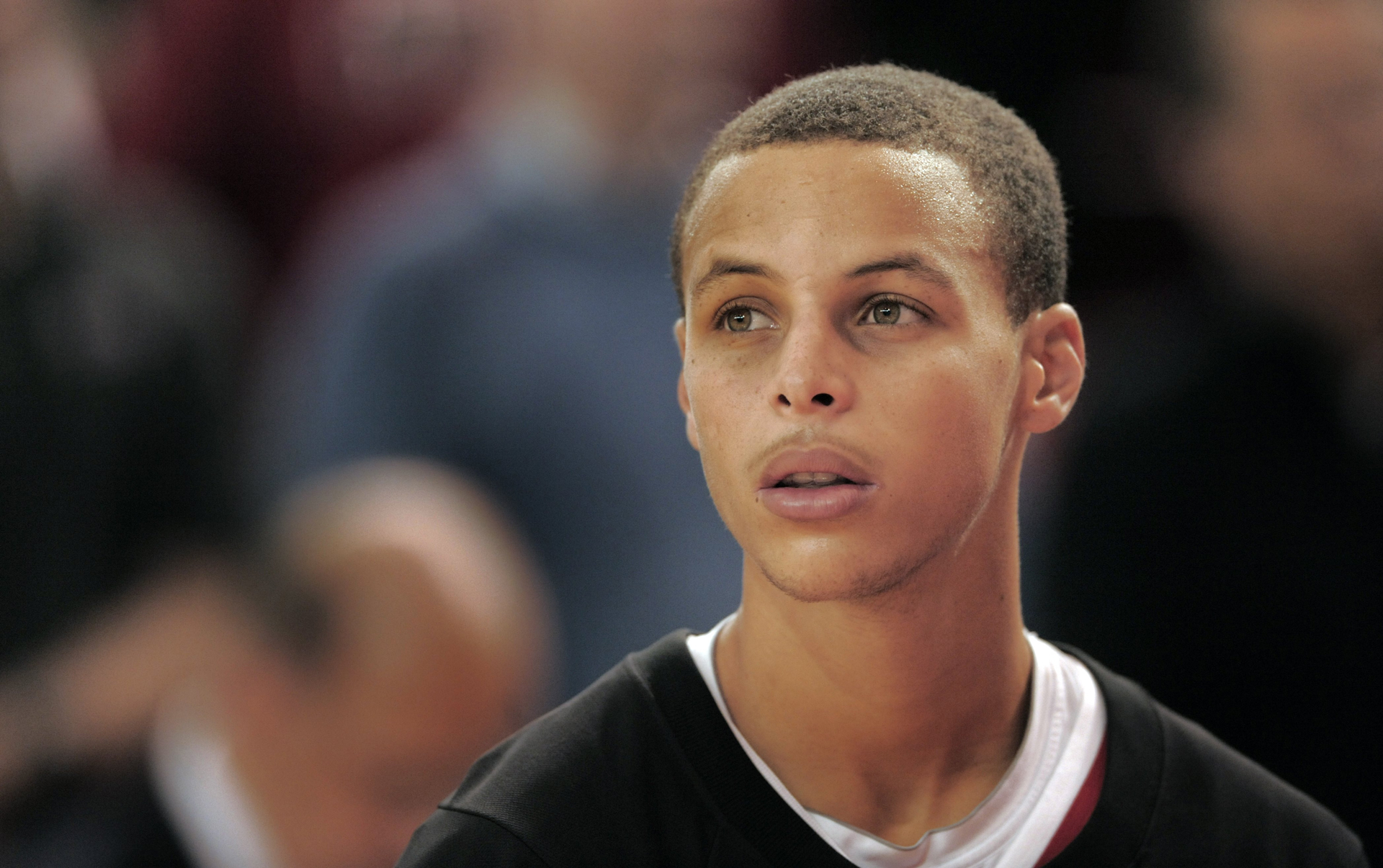 Young Black man with short hair against blurry background