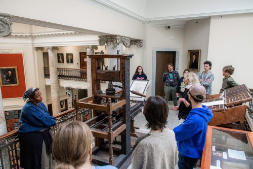 Tour group viewing the 18th-century printing press