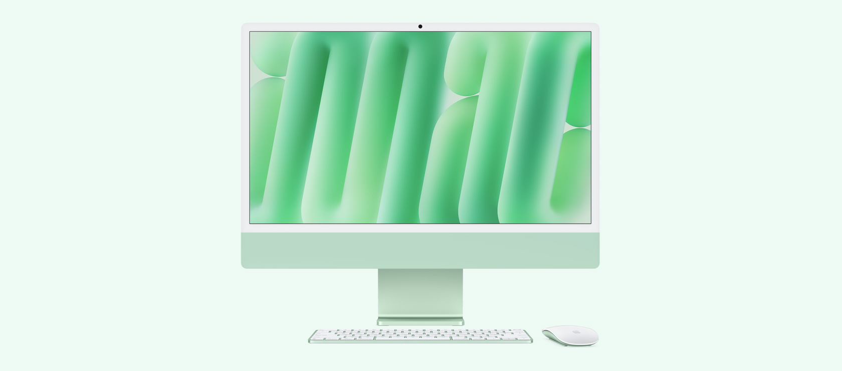 Imagem da frente de um iMac verde com mouse e keyboard na mesma cor