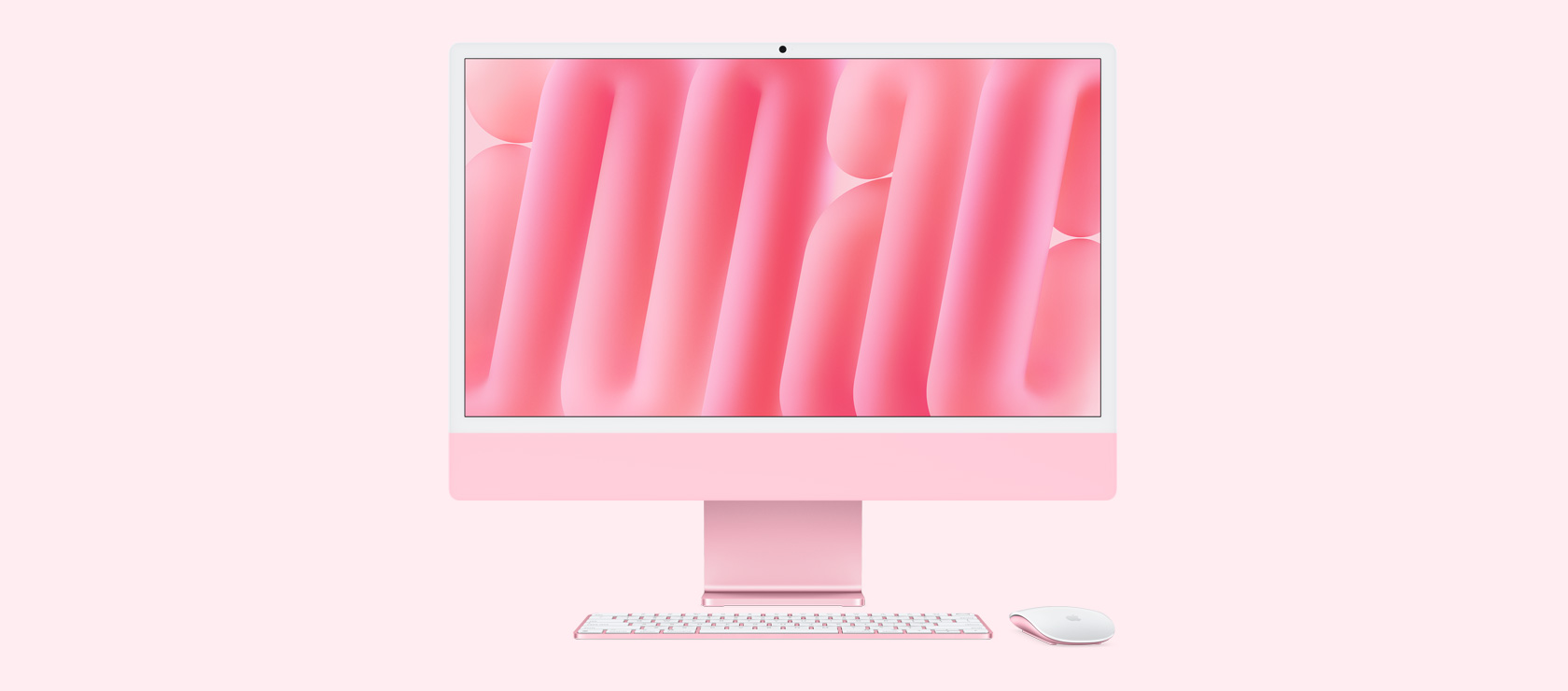 Imagem da frente de um iMac rosa com mouse e keyboard na mesma cor