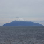 A beach with a mountain in the background.