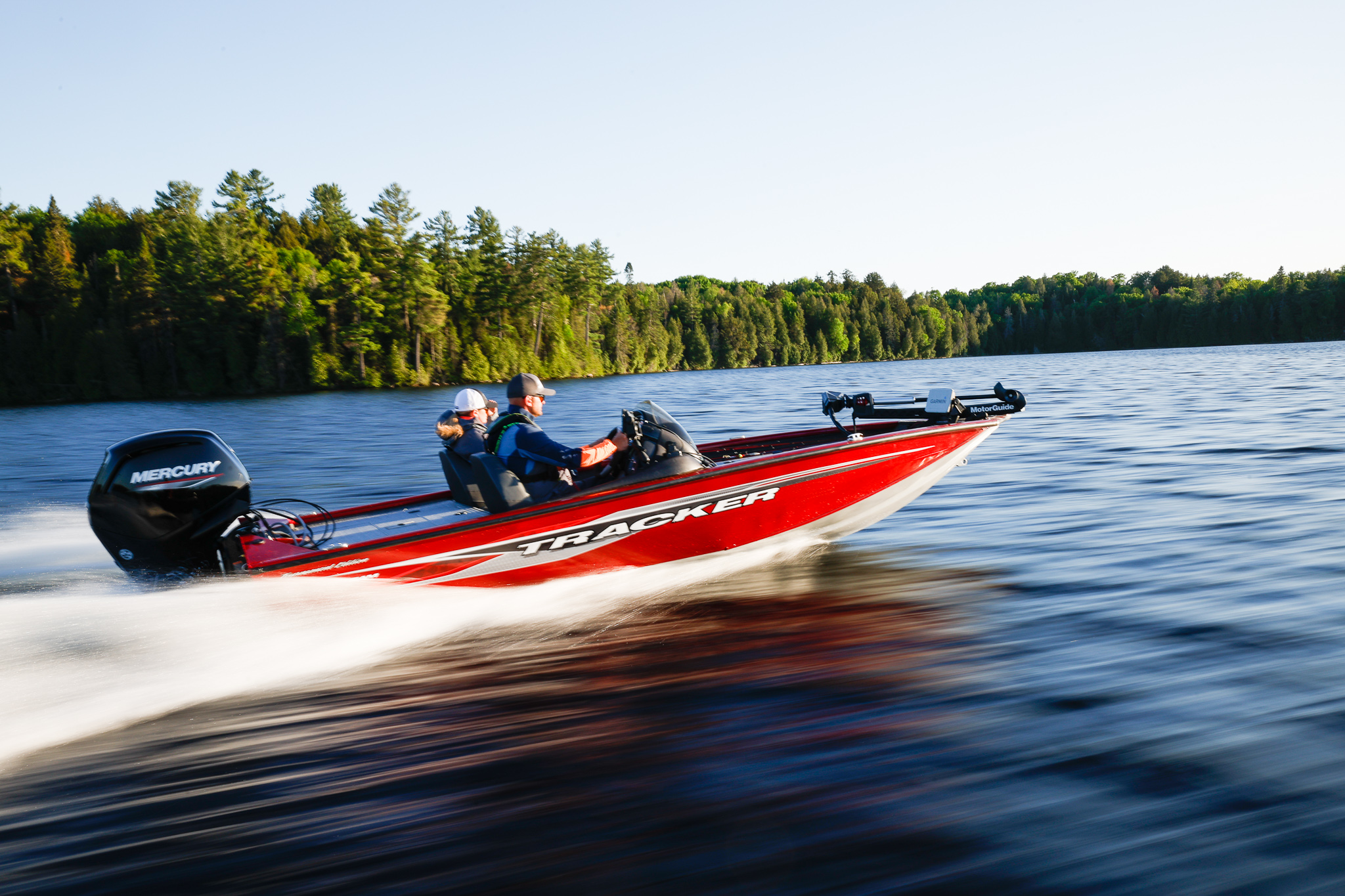 Two men driving a red boat on the water, buy a boat with a boat loan calculator concept. 