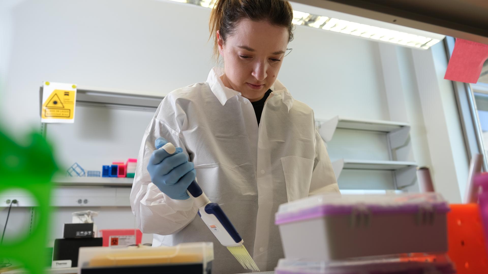 a woman working in a laboratory setting